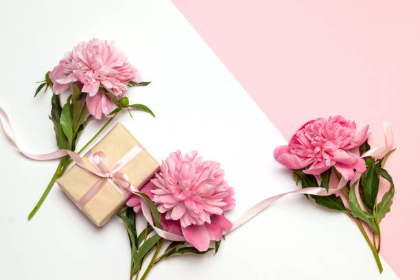 istock A bunch of peonies scattered around randomly with surprise gift boxes in boxes on a white background 1156485002