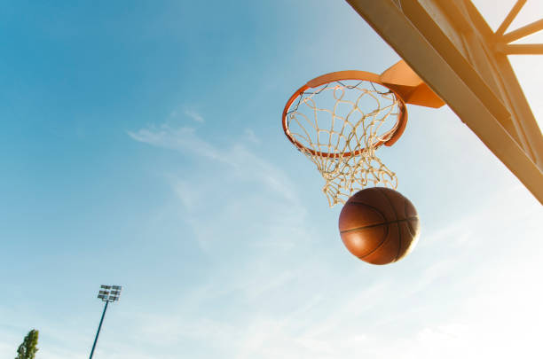istock Basketball ball entering through hoop, scoring a point 1156485718