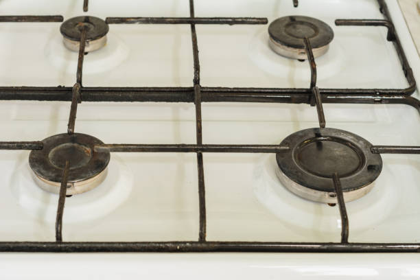 istock White surface with black comforters of a gas stove, close-up. 1156486055