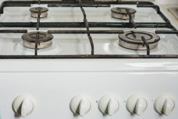 istock White surface with black comforters of a gas stove, close-up. 1156486175