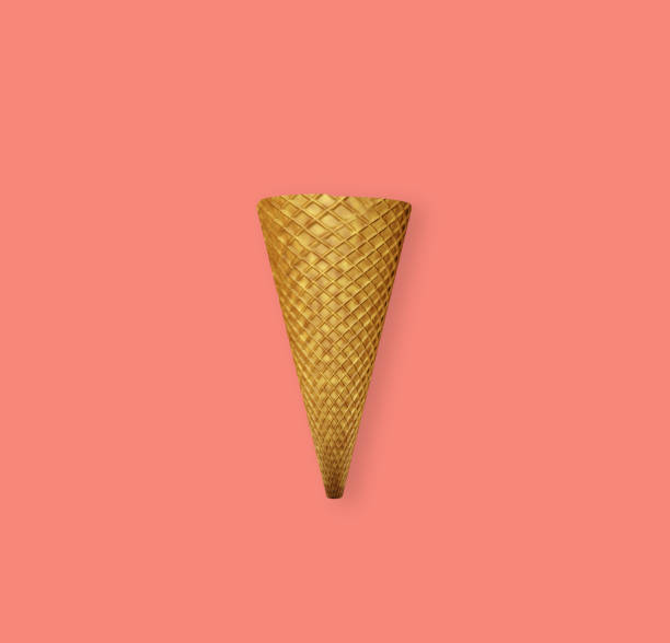 istock Ice cream cone isolated on coral colored background, top view. Summer minimalist dessert composition close-up. 1156487907
