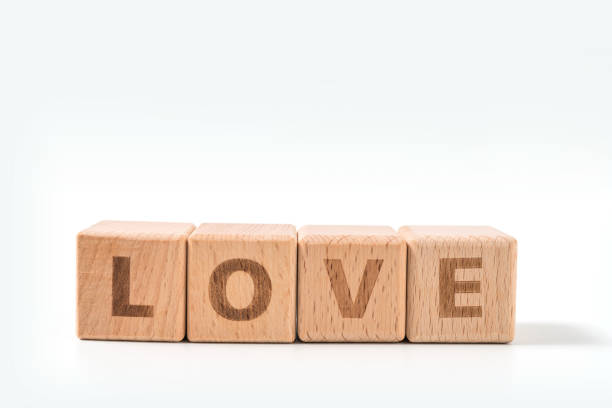 istock word LOVE on wood cube dices on white background. 1156488988