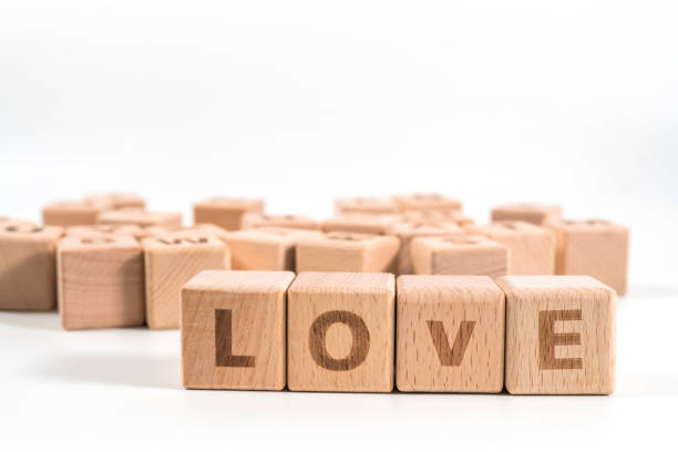 istock word LOVE on wood cube dices on white background. 1156489328