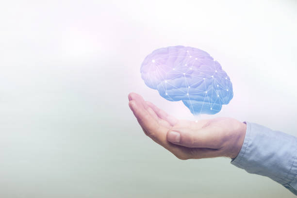istock Human holding brain in palm. Mixed media. 1156492320