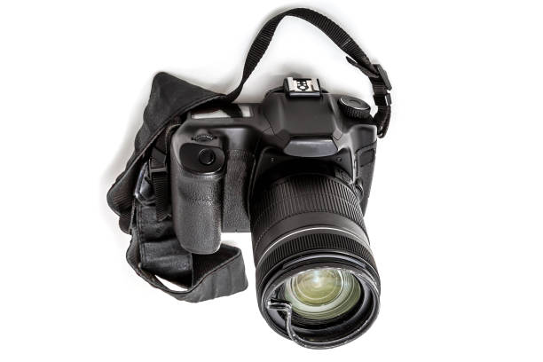 istock Broken digital SLR camera, dented protective filter on the zoom lens. Will be repaired. Isolated on white background. perspective view 1156494145