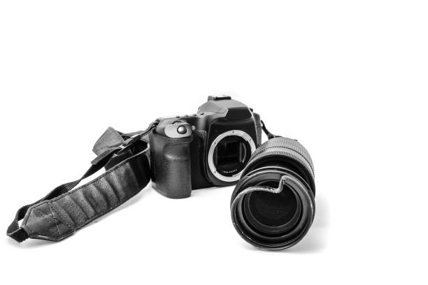 istock Broken digital SLR camera, dented protective filter on the zoom lens. Will be repaired. Isolated on white background. Front view 1156494151