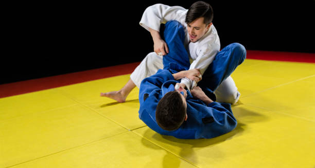 istock Male Judo Players Competing During Match 1156494732
