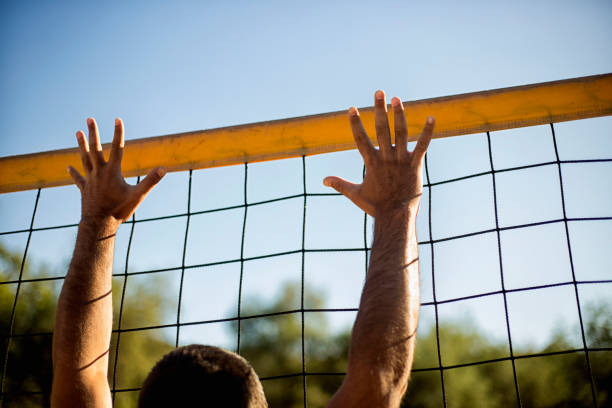 istock Attractive young man playing volleyball on the beach summertime 1156497972