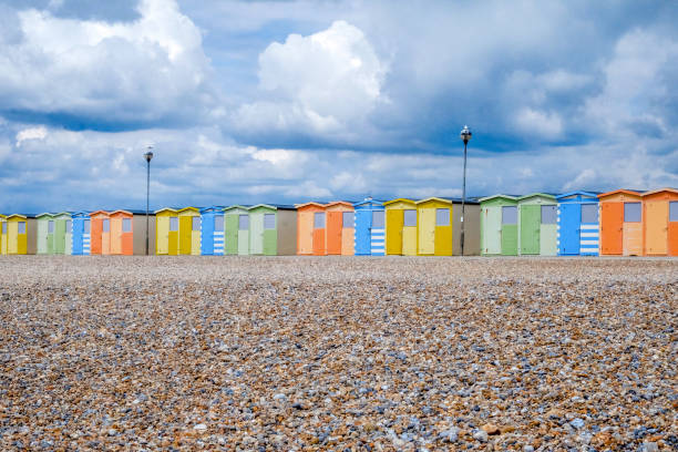istock A line of twenty two colourful beach huts on a pebble beach 1156498518