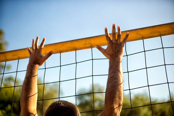 istock Attractive young man playing volleyball on the beach summertime 1156499432
