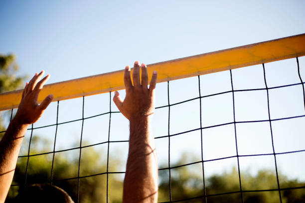 istock Attractive young man playing volleyball on the beach summertime 1156500107