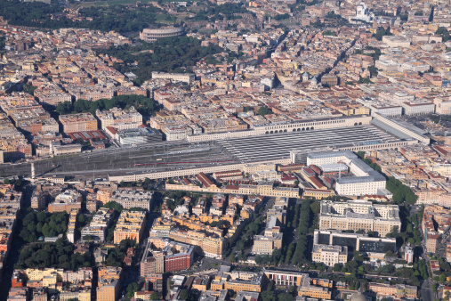 Rome, Italy - aerial view of famous Termini station. With its 29 platforms and over 150 million passengers each year, Roma Termini is one of the largest train stations in Europe. Colosseum in the background.