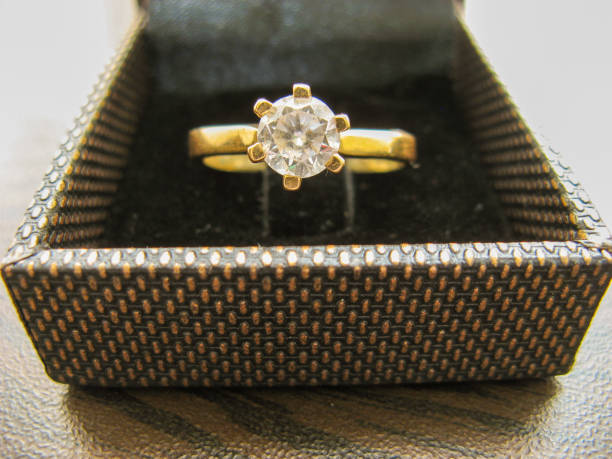 istock Gold wedding ring in box on closeup 1156500158