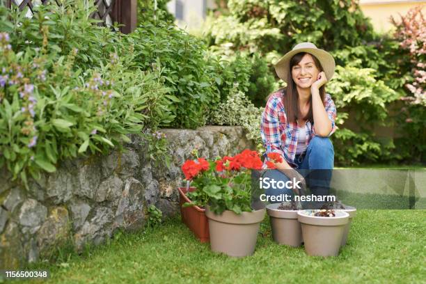 Woman Taking Care Of Flowers Stock Photo - Download Image Now - One Woman Only, Dirt, Shovel