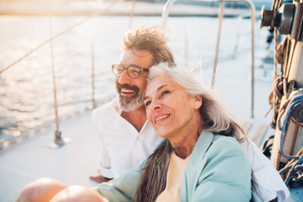 Mature couple smiling Senior couple in love sailing together wealthy lifestyle stock pictures, royalty-free photos & images