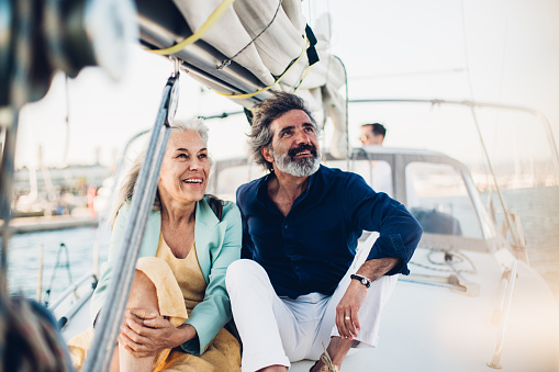 Happy mature couple resting at a boat