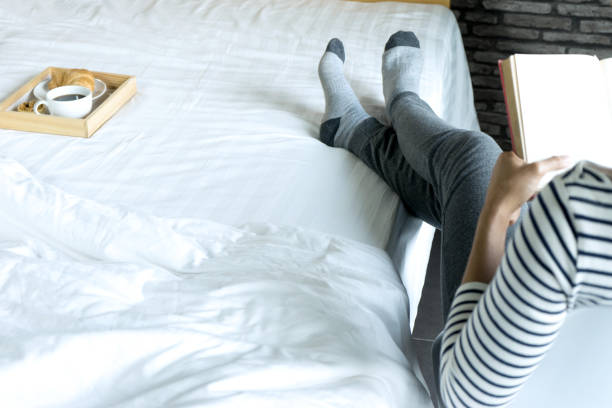 istock relax woman read a book on the bed 1156502379