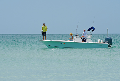 Holmes Beach, Anna Maria Island FL / USA - April 30, 2018: People Fishing from a Power Boat in the Gulf of Mexico