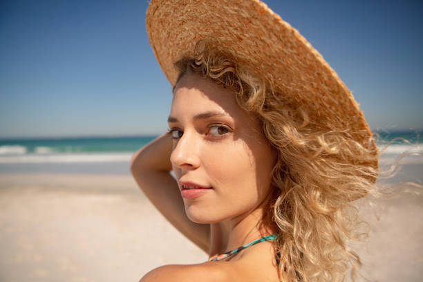 istock Beautiful woman standing on the beach 1156504862