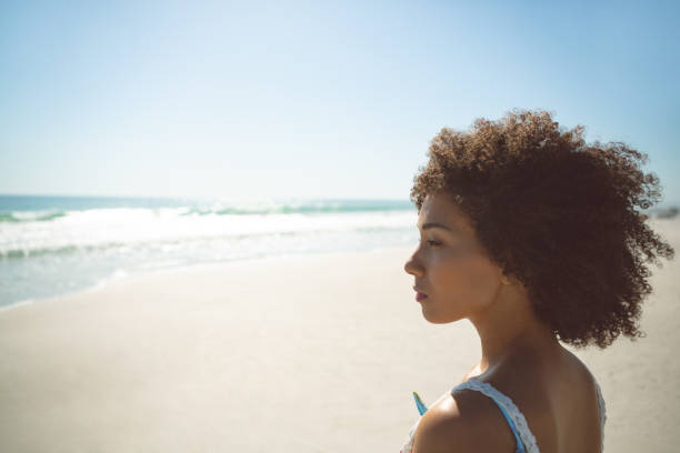 istock Woman standing on the beach 1156506682