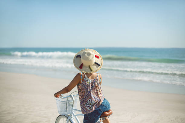 Bicycle leaning against a picket fence on the beach