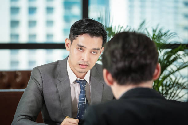 istock Businessman talking in office with young men for job Interview 1156509681