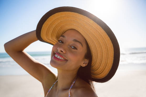 istock Beautiful woman in hat standing on the beach 1156510921