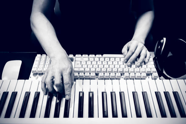 istock male composer hands playing piano for arranging music on computer 1156511454