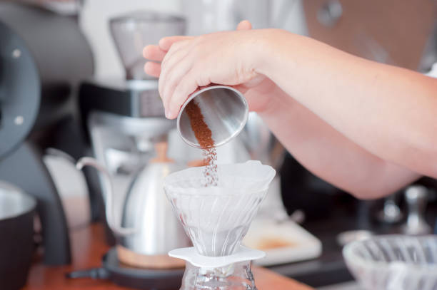 istock Barista hand pouring fresh roasted coffee 1156512339