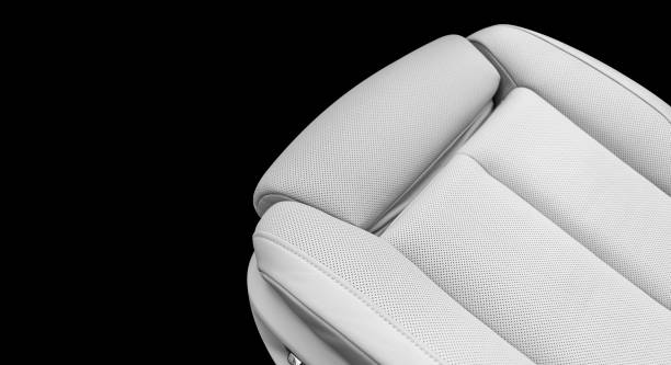 istock White leather interior of a car. Perforated white leather comfortable seats with stitching isolated on black background. Car interior details. Car detailing. Car inside. Black and white 1156512373