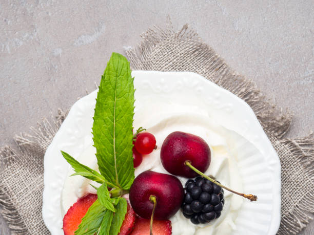 istock Pavlova cakes with cream and fresh summer berries 1156513805