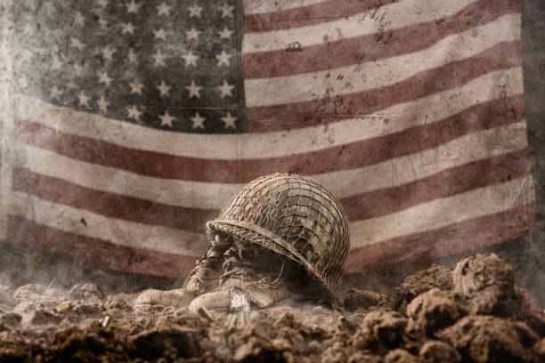 Battlefield memorial for fallen soldier with 48 star US flag A muddy army helmet sitting atop a pair of empty army boots with a pair of dog tags as a memorial to a fallen soldier in battle with a 48 star US flag hanging in the background. This could be from World War II or the Korean war. usa flag shoes stock pictures, royalty-free photos & images