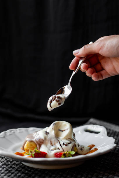 Beautifully decorated plate with fruits, ice cream, waffle and dressing out of a restaurant.