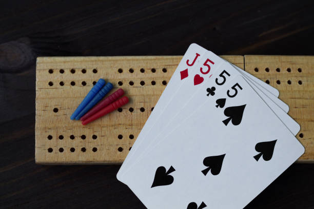 istock playing cards on black background with cribbage board 1156517209