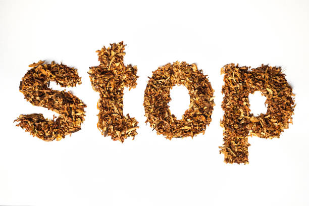 istock Word STOP made of cigarette tobacco underlined by burned cigarette 1156517280