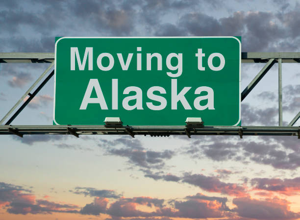 Moving to Alaska Sign A road sign that says "Moving to Alaska." alaska us state photos stock pictures, royalty-free photos & images
