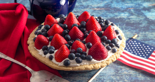 istock Strawberry and Blueberry Fresh Summer Pie on a Distressed Blue Wooden Table 1156520667