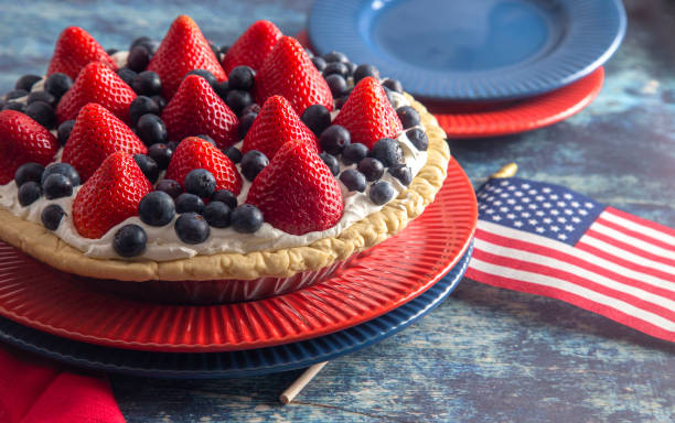 istock Strawberry and Blueberry Fresh Summer Pie on a Distressed Blue Wooden Table 1156520677