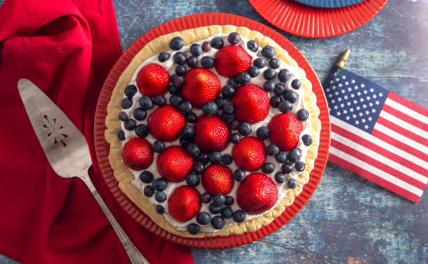 istock Strawberry and Blueberry Fresh Summer Pie on a Distressed Blue Wooden Table 1156520762