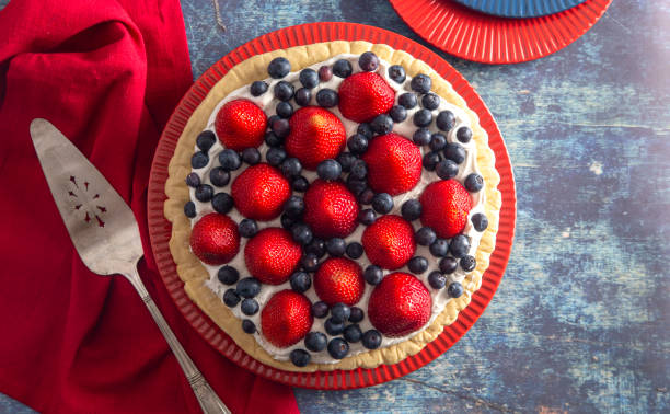 istock Strawberry and Blueberry Fresh Summer Pie on a Distressed Blue Wooden Table 1156520774