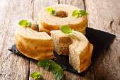 Baumkuchen, translated as tree cake, is a many-layered sponge cake baked on a rotating cylinder close-up. horizontal