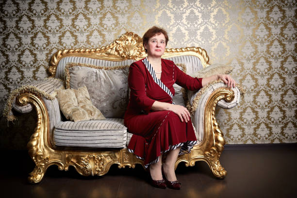 istock Rich elderly woman sitting on an expensive sofa. 1156521286