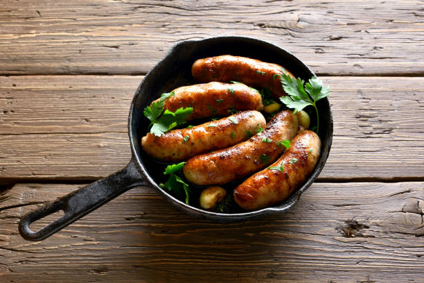 istock Fried sausages in frying pan 1156521360