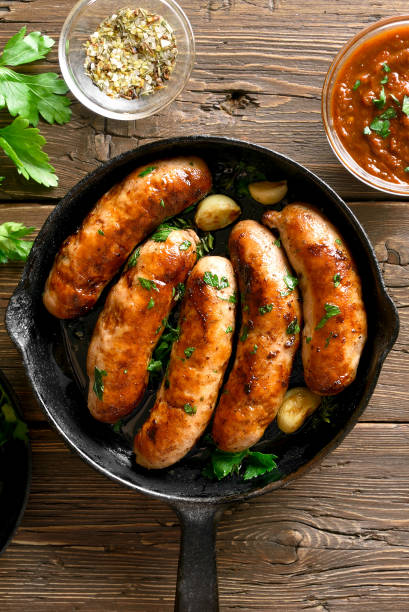 istock Fried sausages in frying pan 1156521396
