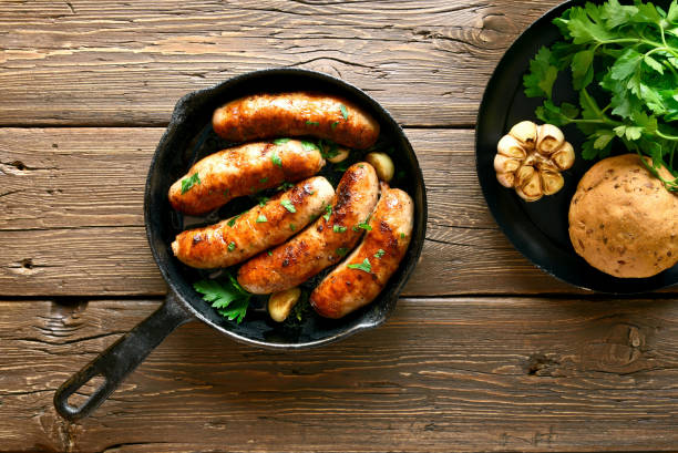 istock Fried sausages in frying pan 1156521403