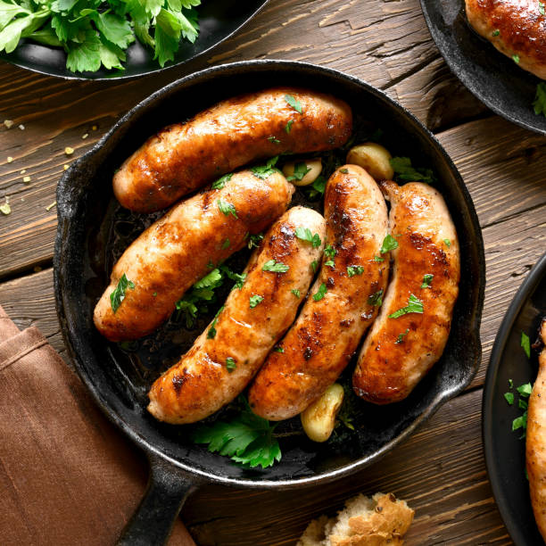 istock Fried sausages in frying pan 1156521406