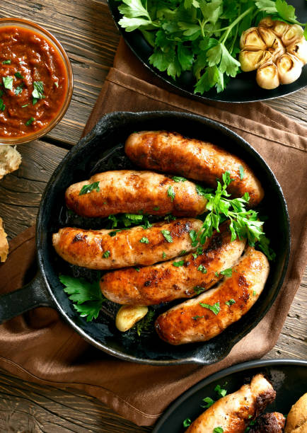 istock Fried sausages in frying pan 1156521444