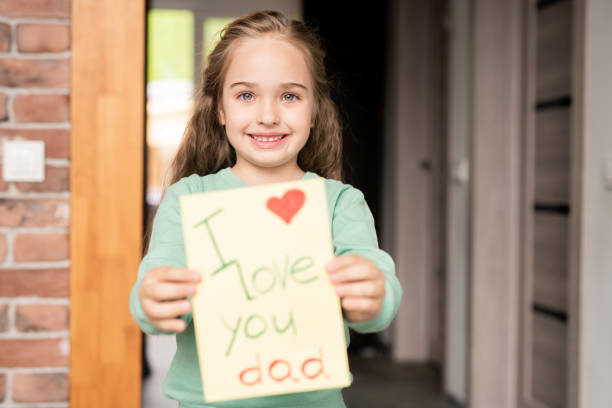 istock Giving greeting card to father 1156522174
