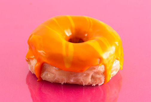 An Orange Striped Glazed Donut