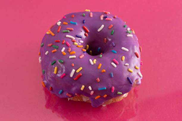 istock A Purple Glazed Donut with Rainbow Sprinkles on Top 1156522540